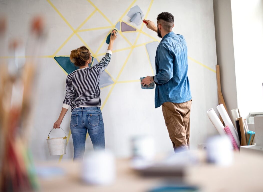 rear-view-of-couple-painting-wall-indoors-at-home-2024-10-21-09-35-12-utc (Medium)